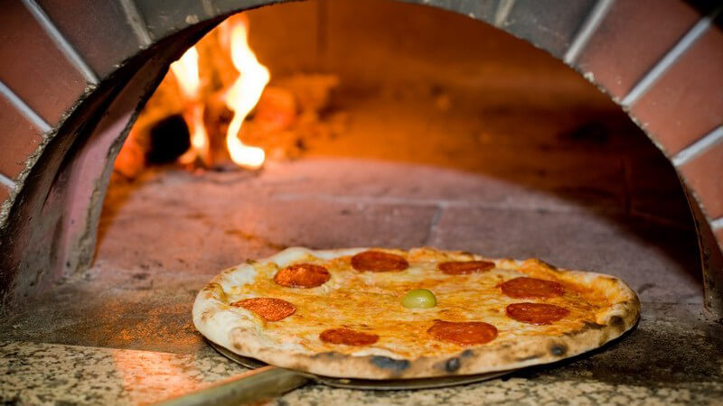 Ein Steinbackofen lässt sich auf vielfältige Art einsetzen - eine Pizza wie aus so einem Ofen bekommt man zum Teil aber auch schon durch die Verwendung eines Pizzasteins