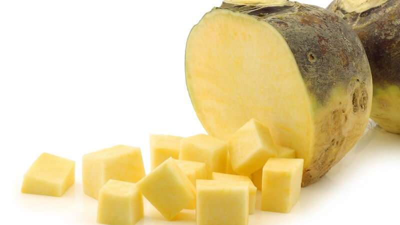 Speiserübe und klein geschnittene Würfel vor weißem Hintergrund