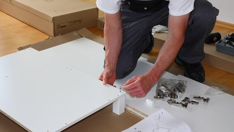Heimwerker baut Möbel zusammen