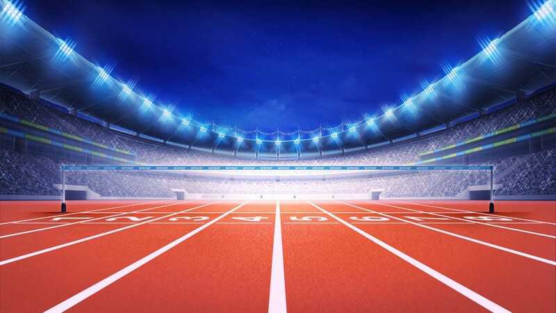 Blick auf die Ziellinie einer Laufstrecke im Leichtathletik-Stadion mit Flutlicht