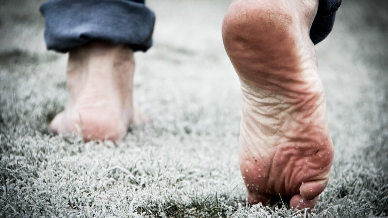Barfußlaufen auf mit Frost bedecktem Gras (Tautreten)